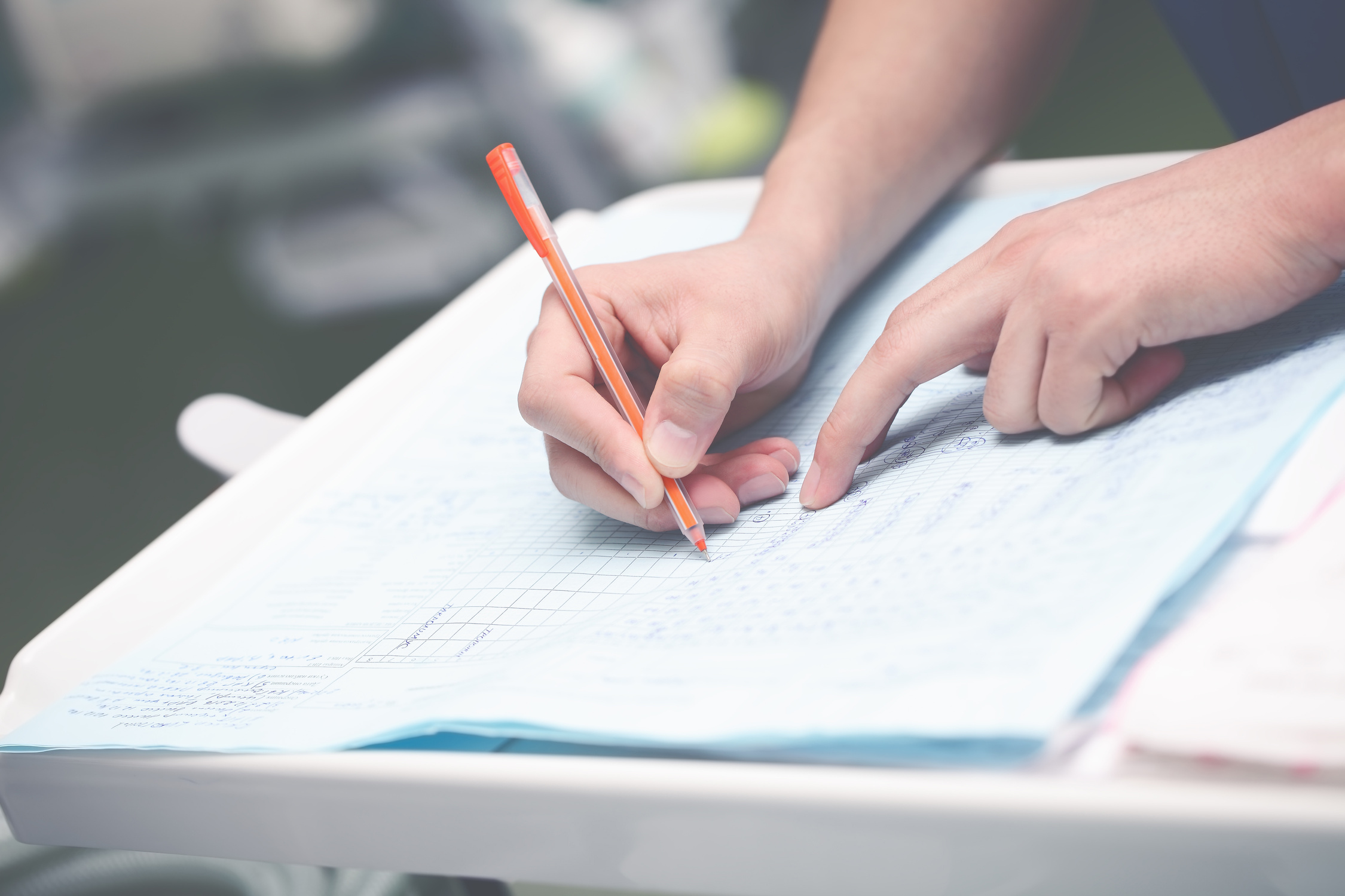Doctor Writing Medical Report in Office